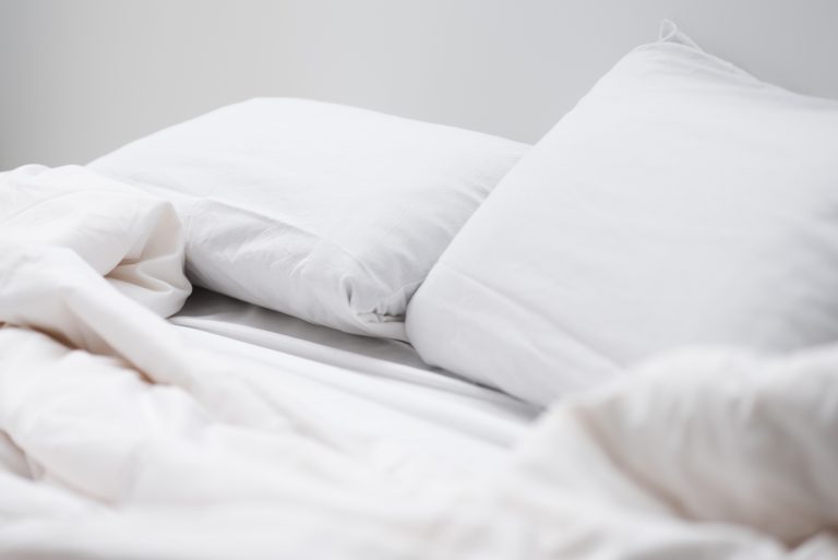 Image of bed with white sheets - MoveStore can store your bedding and soft furnishings in our clean and dry storage containers.