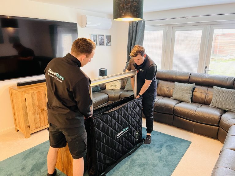 MoveStore removal men packing a home for removal. Artwork is being put in a special protector