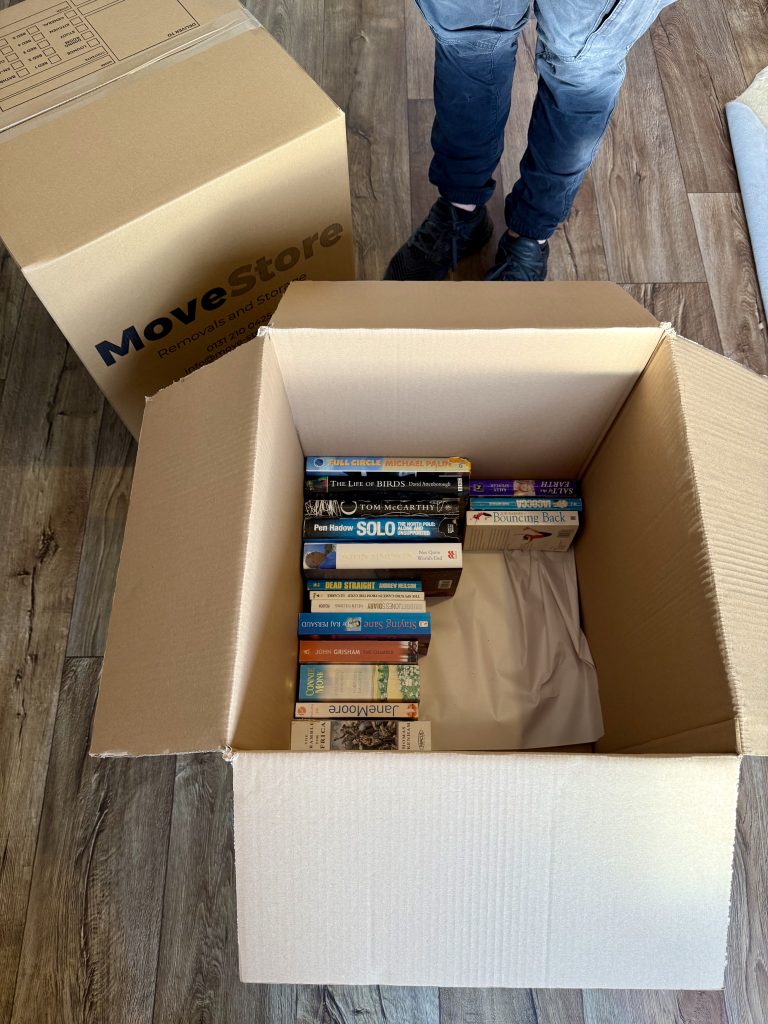 MoveStore's packing service - image of books being packed into boxes.