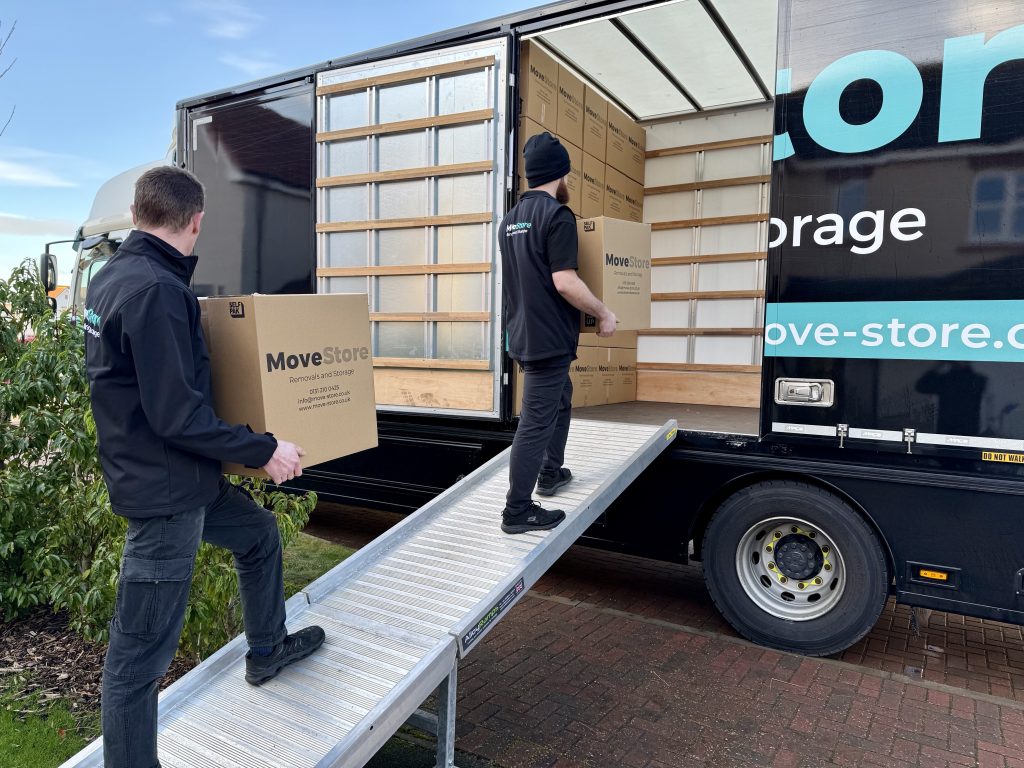 House Removals by MoveStore. Movers carrying MoveStore boxes onto their removals lorry