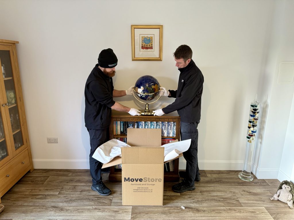 MoveStore movers packing an ornament carefully with white gloves