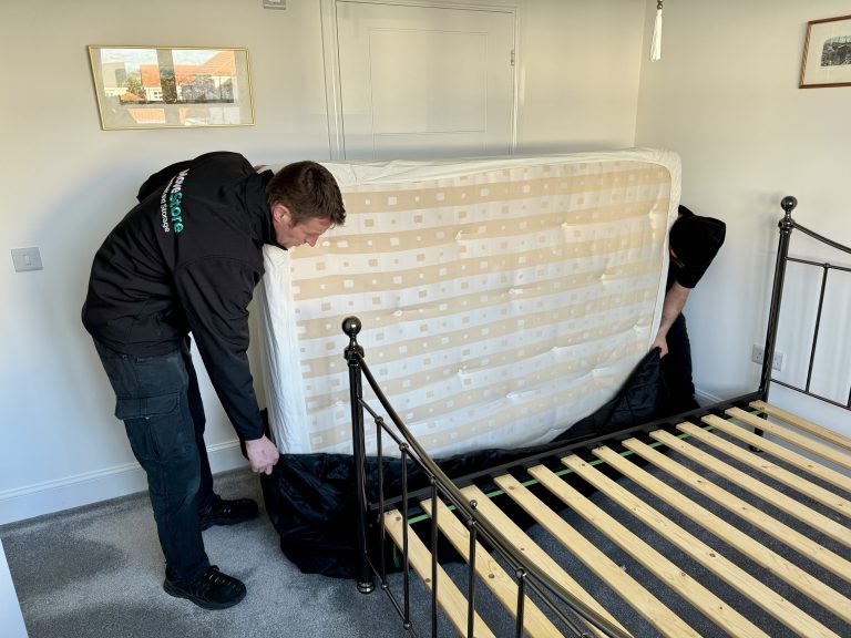 MoveStore Removals putting a mattress in one of their mattress protectors for moving house